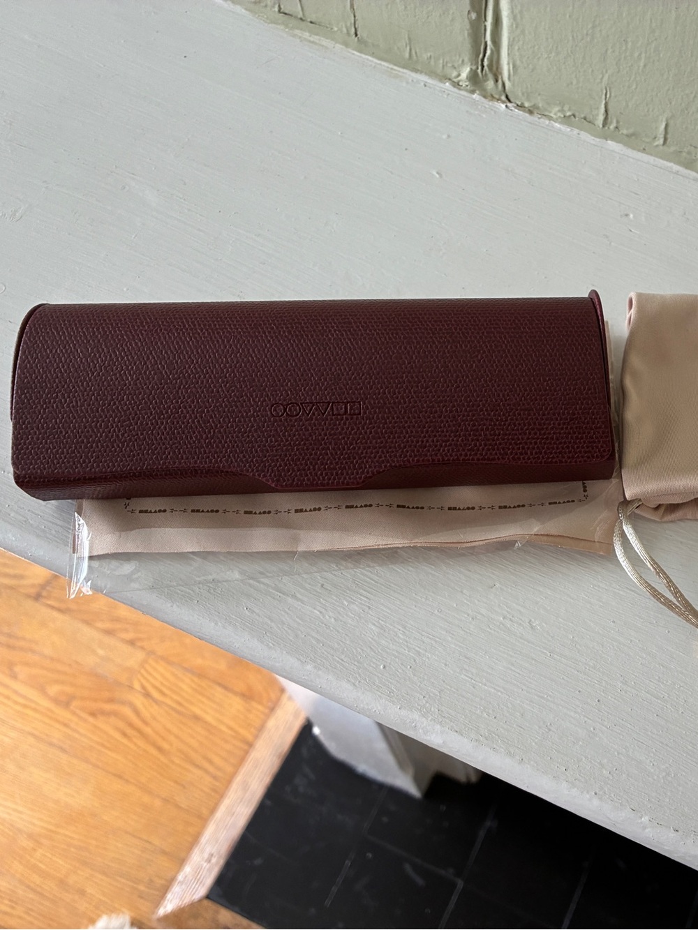 Oliver Peoples Burgundy Leather Eyewear Case with Cream Drawstring Pouch